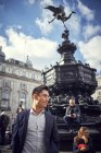Asian man standing at Piccadilly Circus — Stock Photo