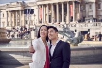 Paar macht Selfie gegen Brunnen am Trafalgar Square — Stockfoto