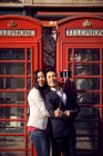 Couple taking selfie against phone boxes — Stock Photo