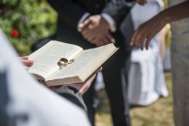 Wedding rings rest on Bible — Stock Photo