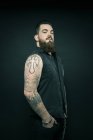 Чоловік з татуйованими руками в кишенях — стокове фото