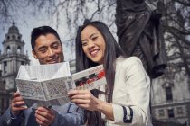 Couple in London reading map — Stock Photo