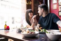 Couple enjoying meal in coffee shop — Stock Photo