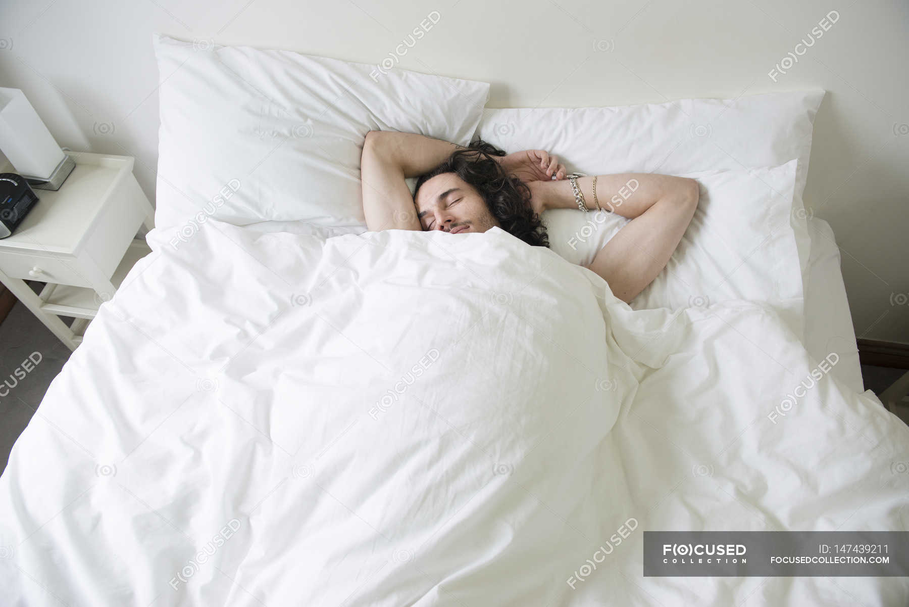 man-lying-in-bed-people-lying-down-stock-photo-147439211