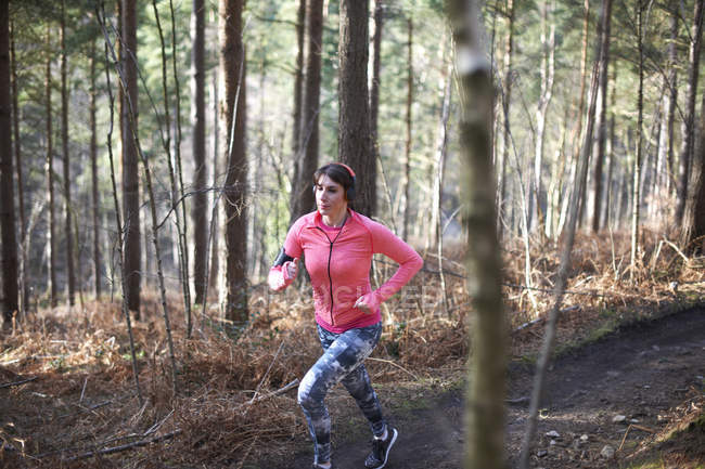 Donna che corre nel bosco — Foto stock