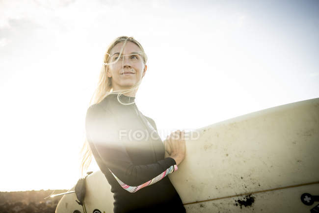 Жінка в гідрокостюмі готується до серфінгу — стокове фото