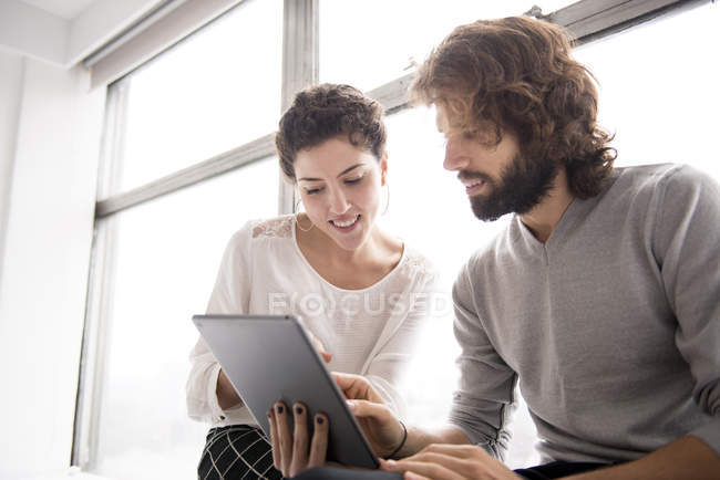 Colleagues using digital tablet — Stock Photo