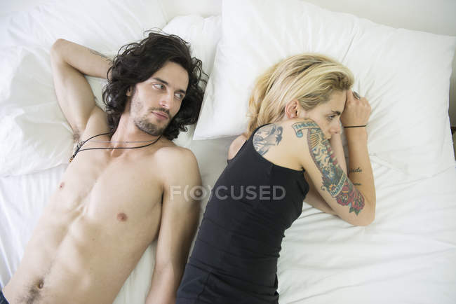 Couple lying on bed after argument — Stock Photo