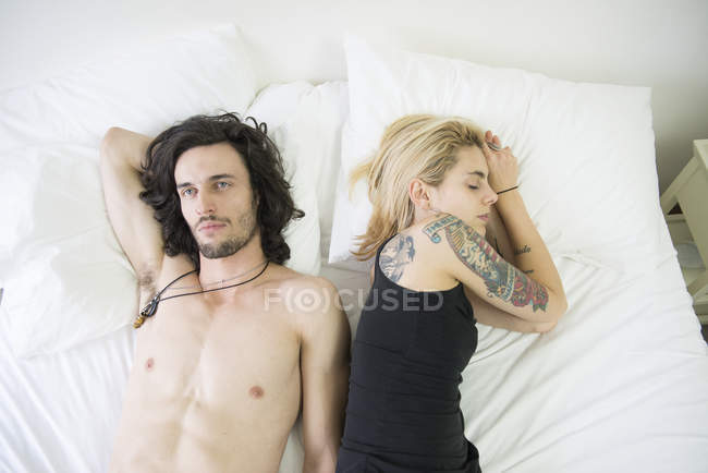 Couple lying on bed after argument — Stock Photo