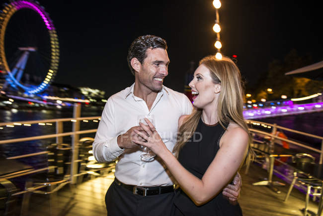Couple enjoying drink on deck of boat — Stock Photo