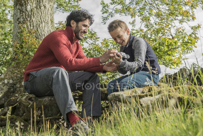 Man showing son how to use camera — Stock Photo