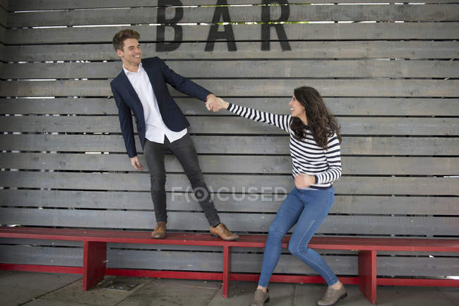 Couple having fun behind bar — Stock Photo