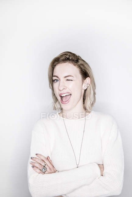 Blonde woman winking at the camera — Stock Photo