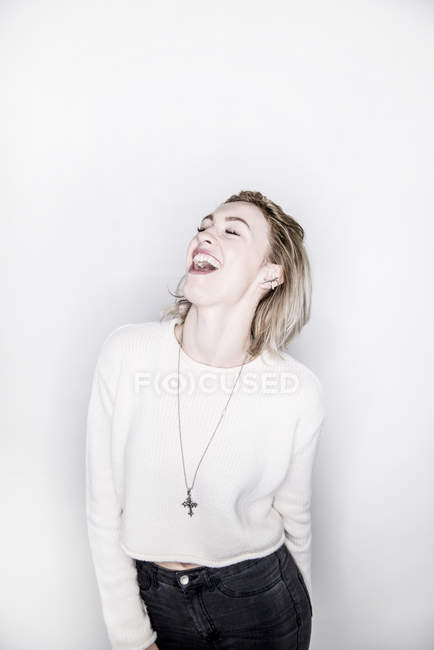 Blonde woman singing with closed eyes — Stock Photo