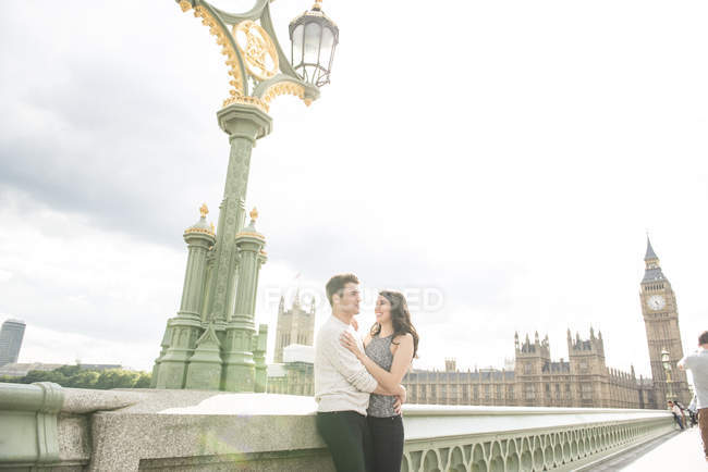 Couple cuddling on Westminster Bridge — Stock Photo