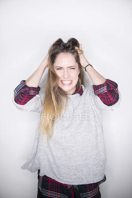 Woman posing in studio looking frustrated — Stock Photo