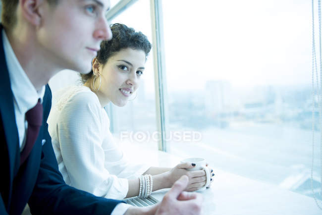 Colleagues standing at window — Stock Photo