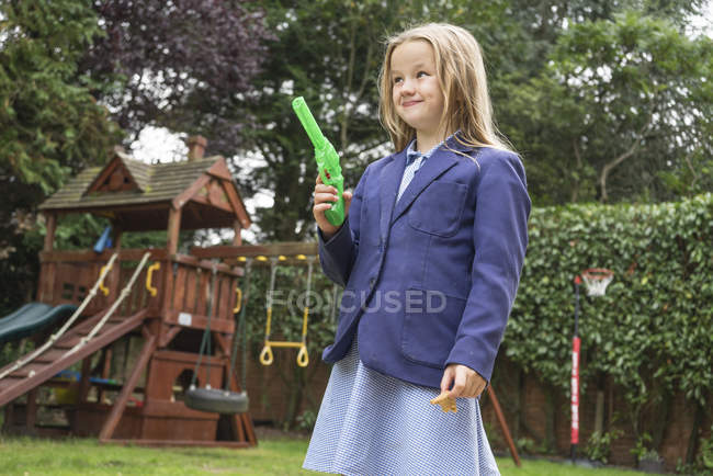 Girl holding water pistol — Stock Photo