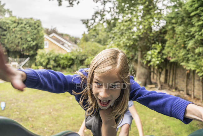 Girl climbing on playground apparatus — Stock Photo