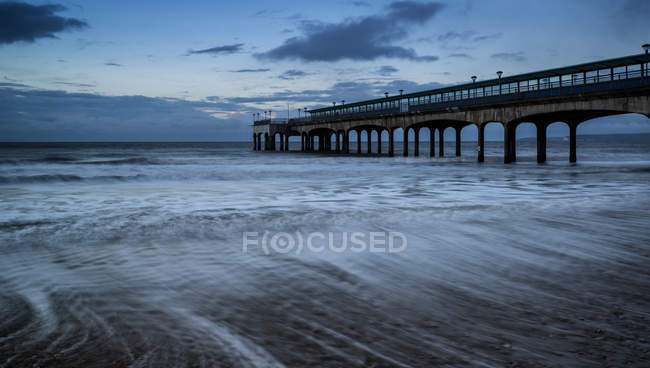 Landscape of pier stretching out into sea — Stock Photo