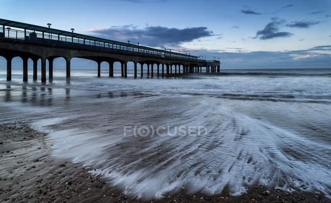 Landscape of pier stretching out into sea — Stock Photo