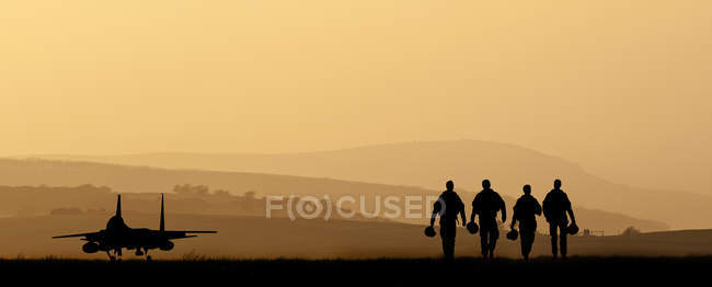 Silhuetas de tripulação militar caminhando — Fotografia de Stock