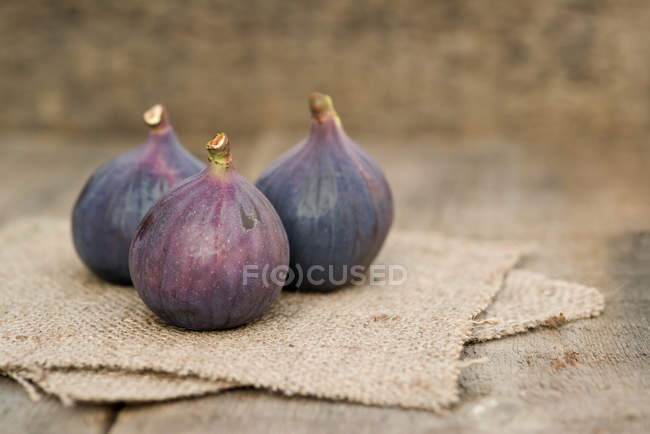 Fresh whole figs on hessian fabric — Stock Photo
