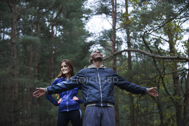 Young couple enjoying forest environment — Stock Photo