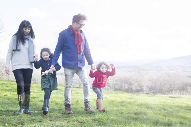 Mother and father with two children in garden — Stock Photo