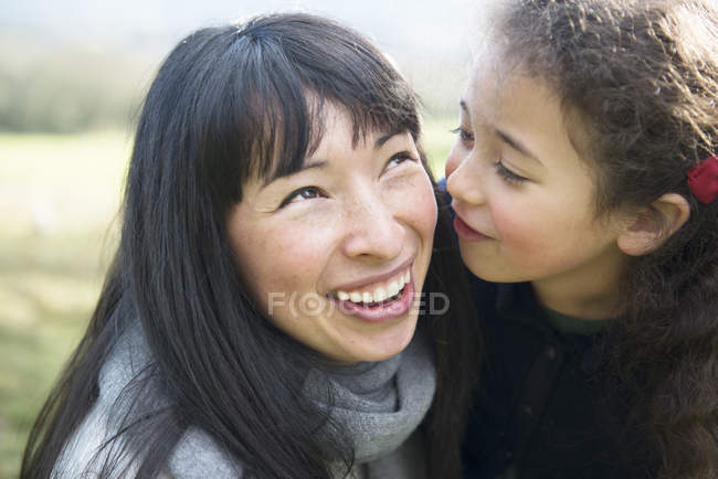 Mother and daughter in spring garden — Stock Photo