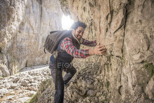 Alpiniste traversant le rebord rocheux — Photo de stock
