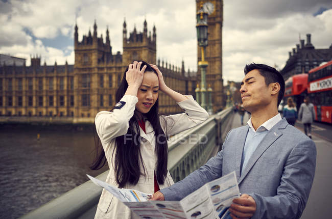 Couple arguing while looking at travel map — Stock Photo