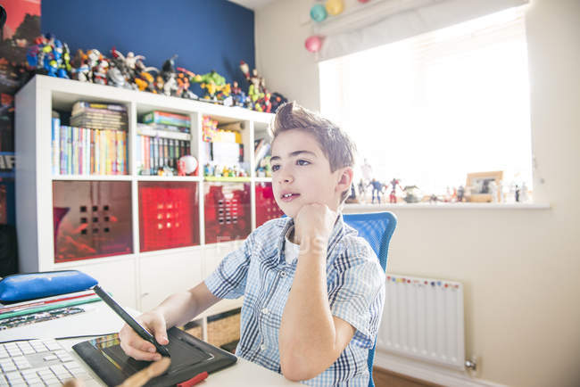 Boy drawing with graphic tablet — Stock Photo