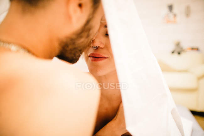 Couple embracing in bed — Stock Photo