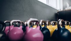 Kettlebells colorés en salle de gym — Photo de stock