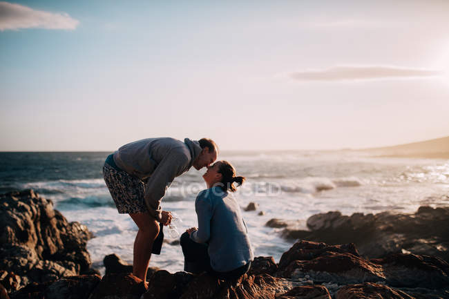 Пара целуется на скале — стоковое фото