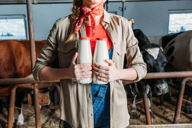 Agriculteur avec du lait frais en stalle — Photo de stock