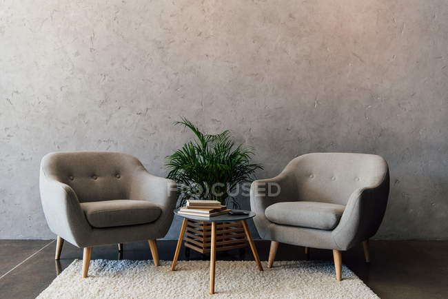 Grey armchairs on carpet — Stock Photo