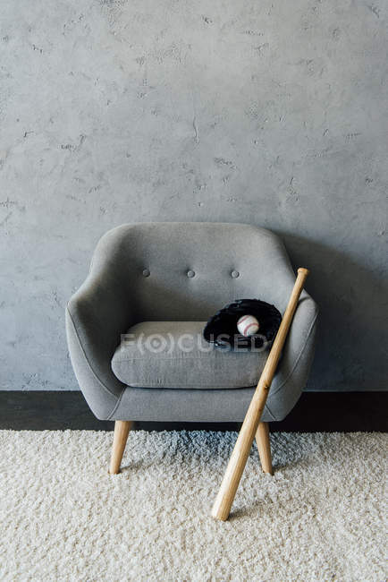 Baseballschläger und Ball mit Handschuh auf Sessel — Stockfoto