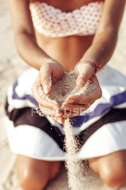 Woman hands holding sand on the beach — Stock Photo