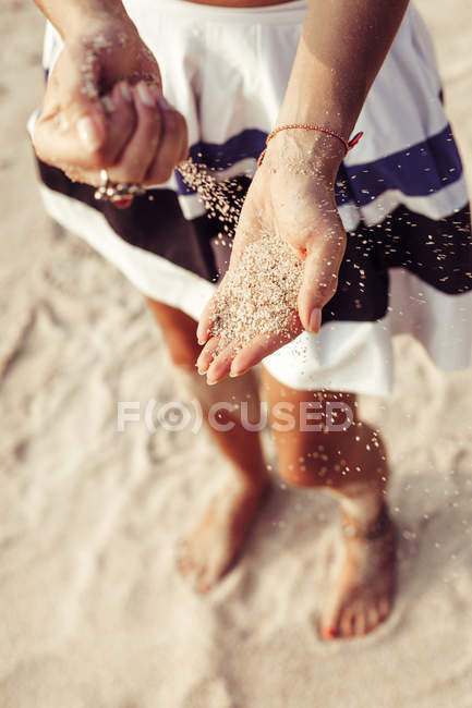 Woman hands holding sand on the beach — Stock Photo