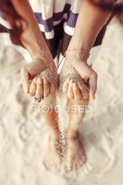 Woman hands holding sand on the beach — Stock Photo