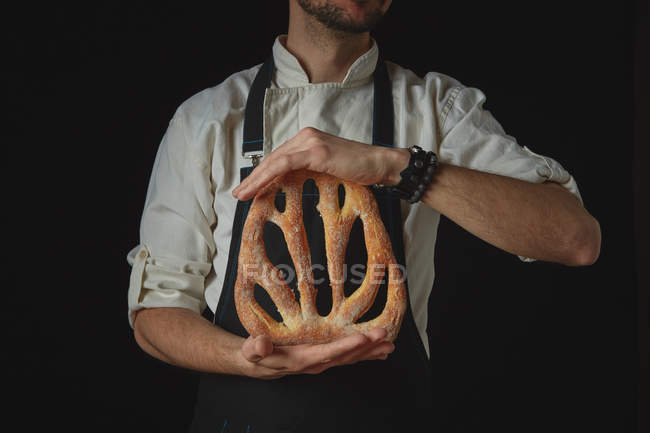 Bäcker hält Laib Brot — Stockfoto