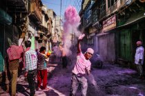 Boy throwing colored powder — Stock Photo