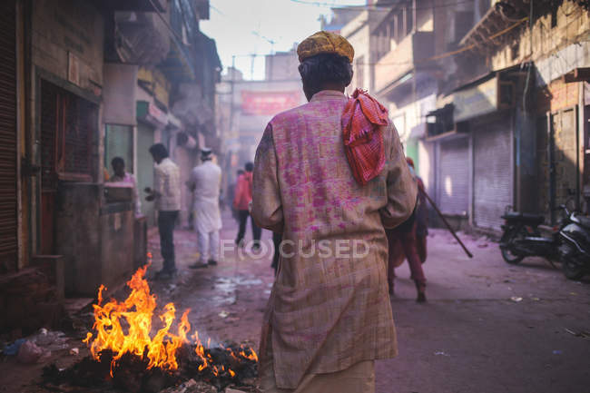 Man walking towards fire — Stock Photo