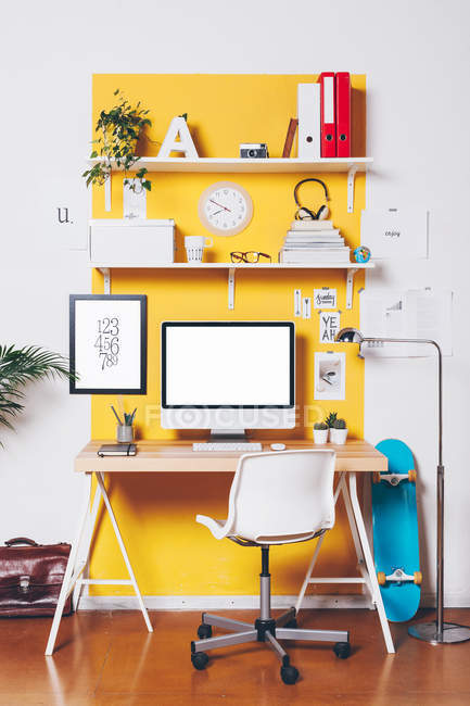 Modern creative workspace on yellow wall. — Stock Photo