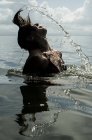Girl splashing with hair — Stock Photo
