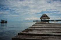 Hut at end of wooden pier — Stock Photo