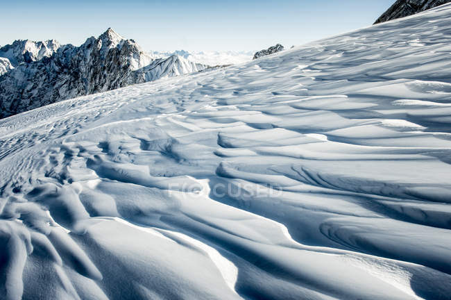 Snowy slope in mountains — Stock Photo