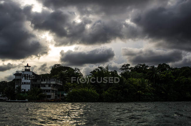 Stormy clouds over private building — Stock Photo